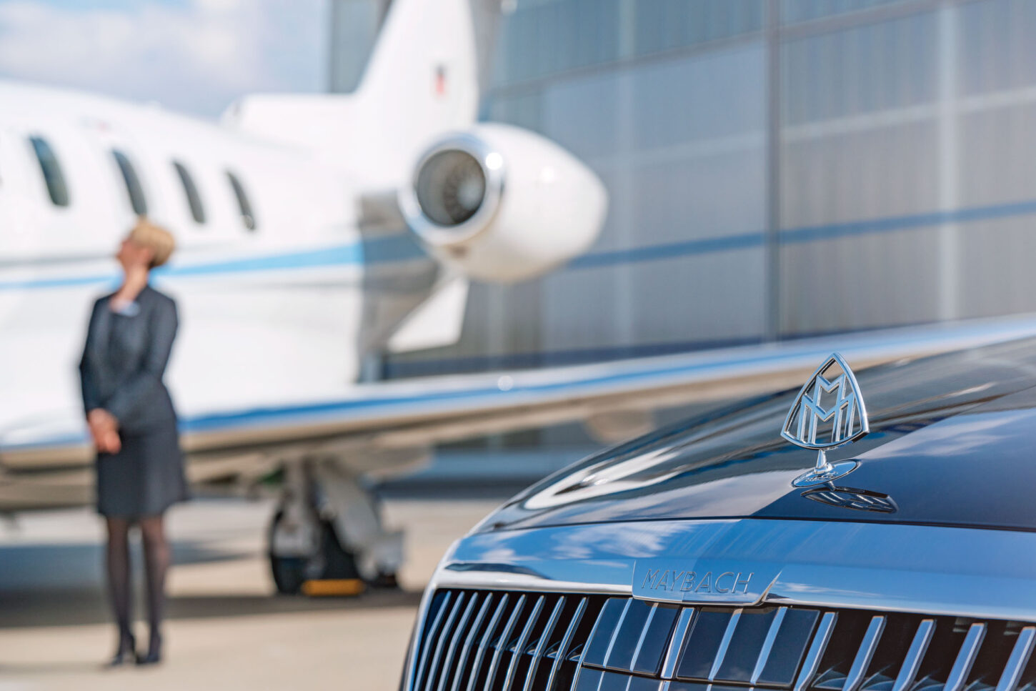 Maybach limousine in the foreground, aircraft and flight attendant in the background